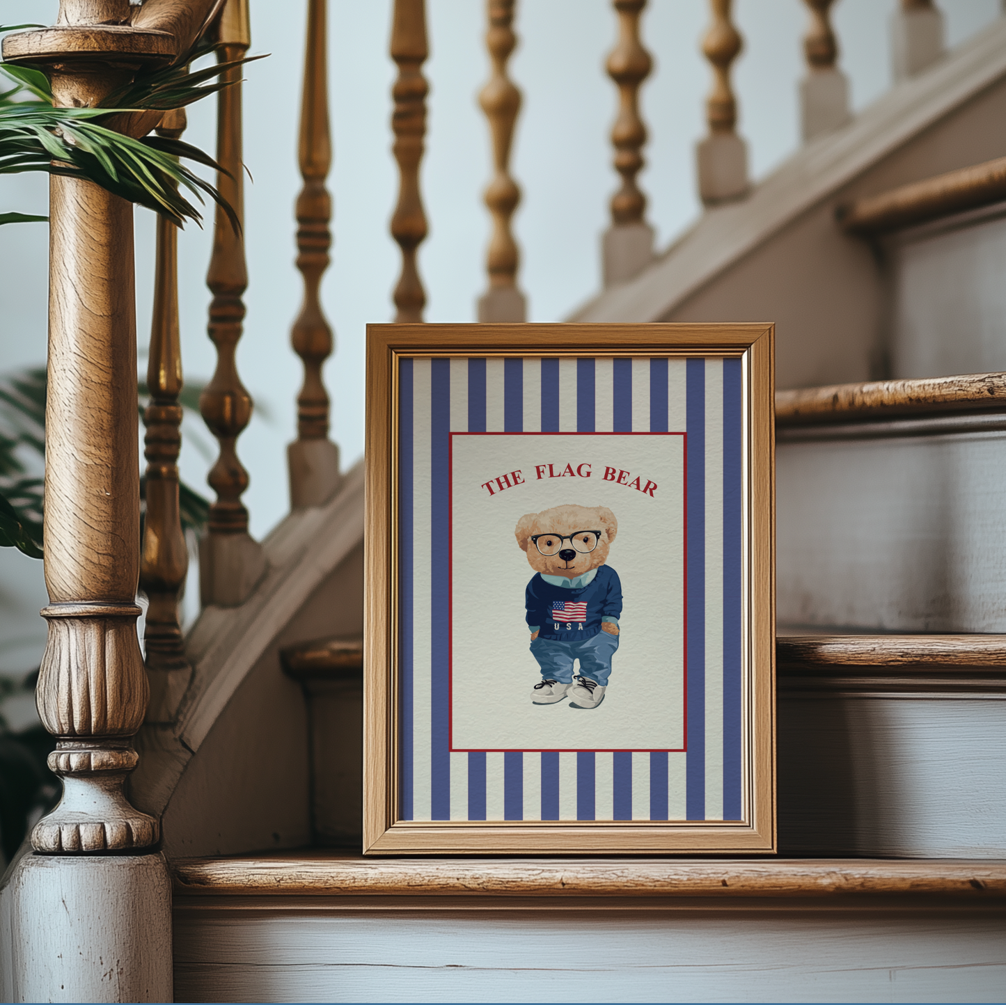 Framed picture of a teddy bear with 'The Flag Bear' text on a striped background, placed on a staircase.